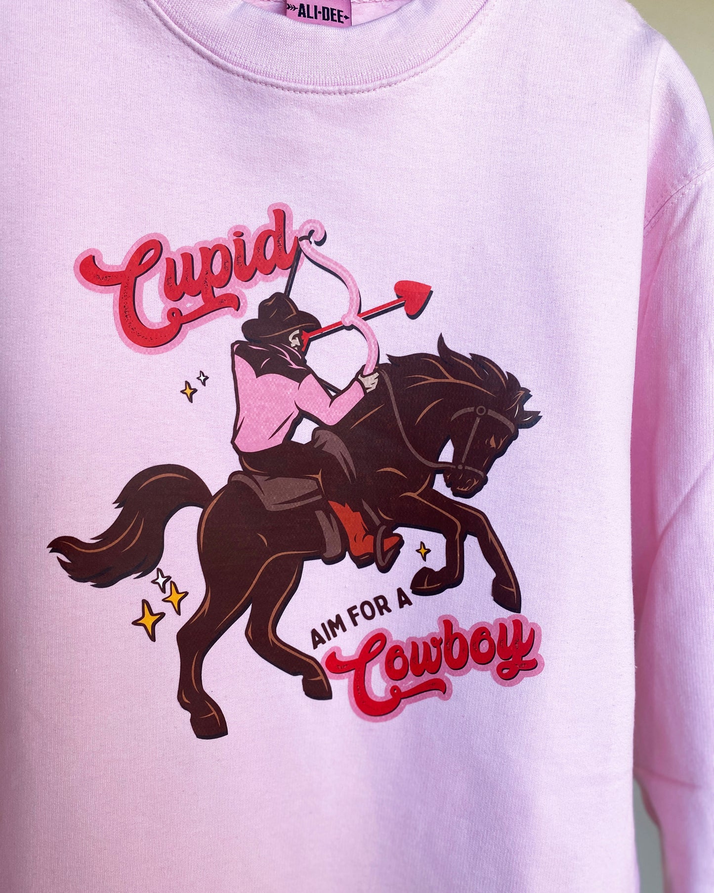 Cupid Aim for A Cowboy Valentines Day Graphic Sweatshirt - Pink